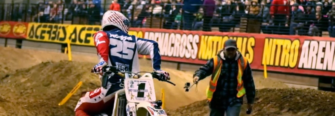 Complete a full lap on an industry standard arenacross track while riding a dirt bike backwards.